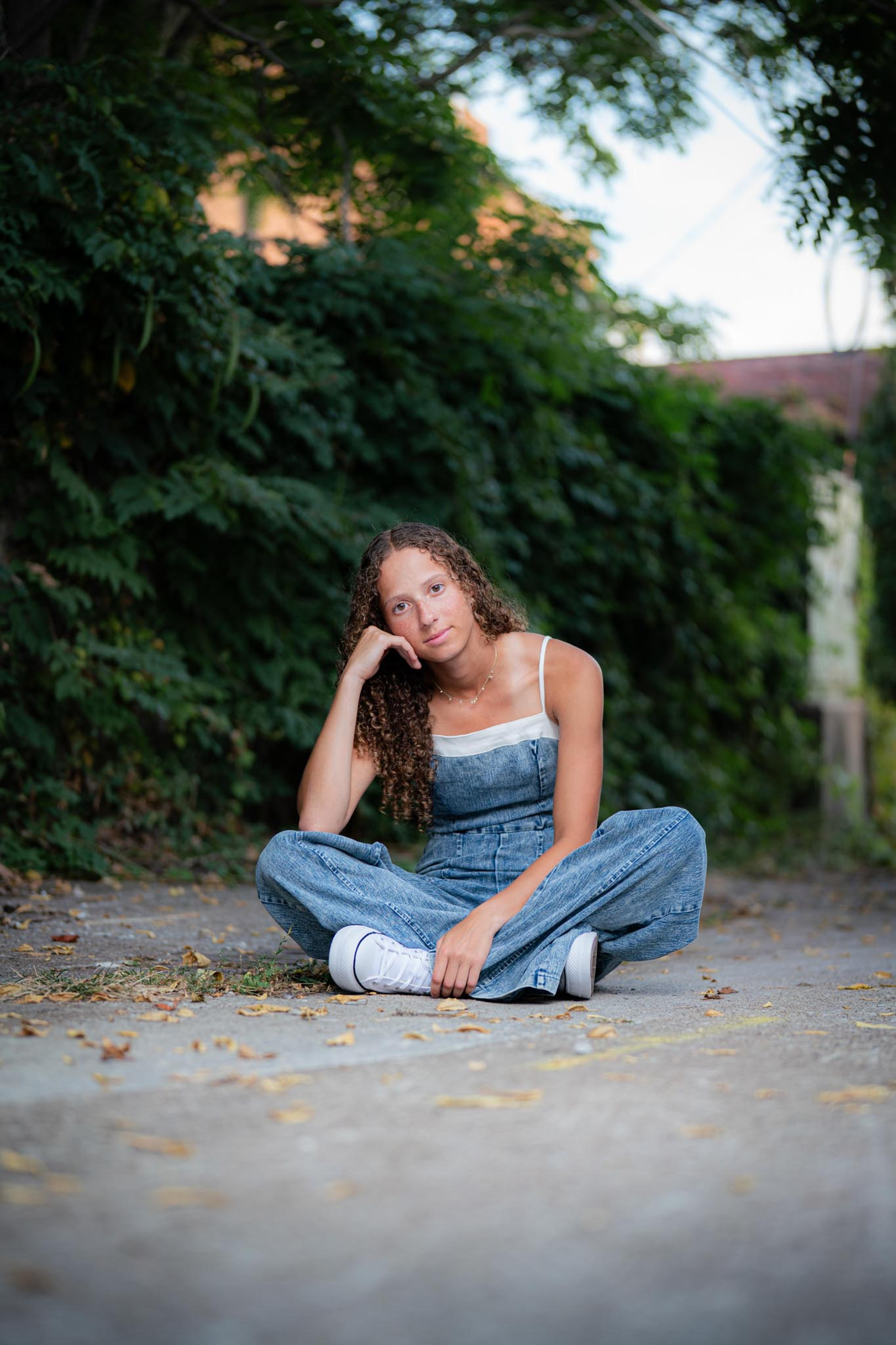 Portrait session on a wooded path, subject in overalls