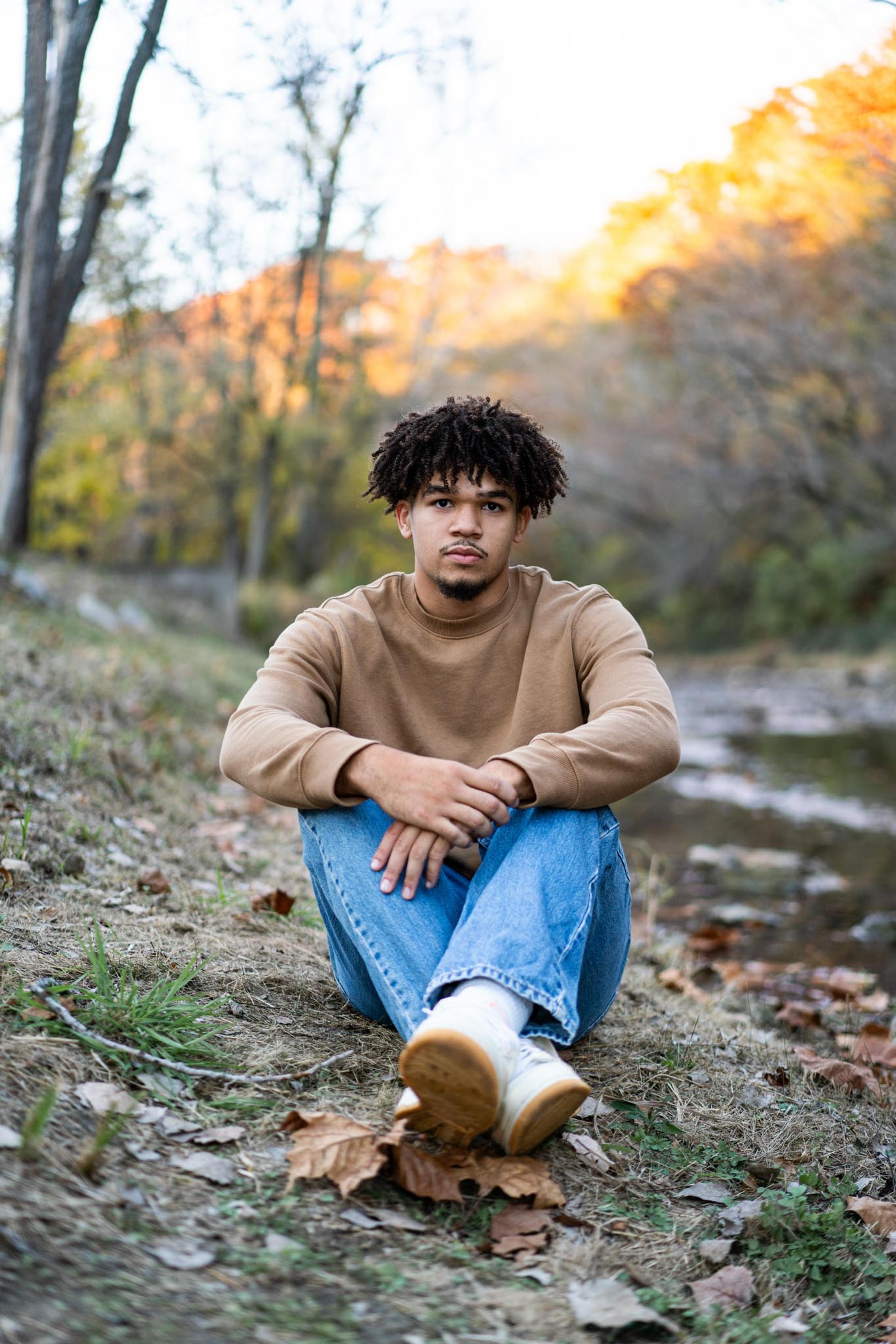 Portrait by a creek in fall foliage