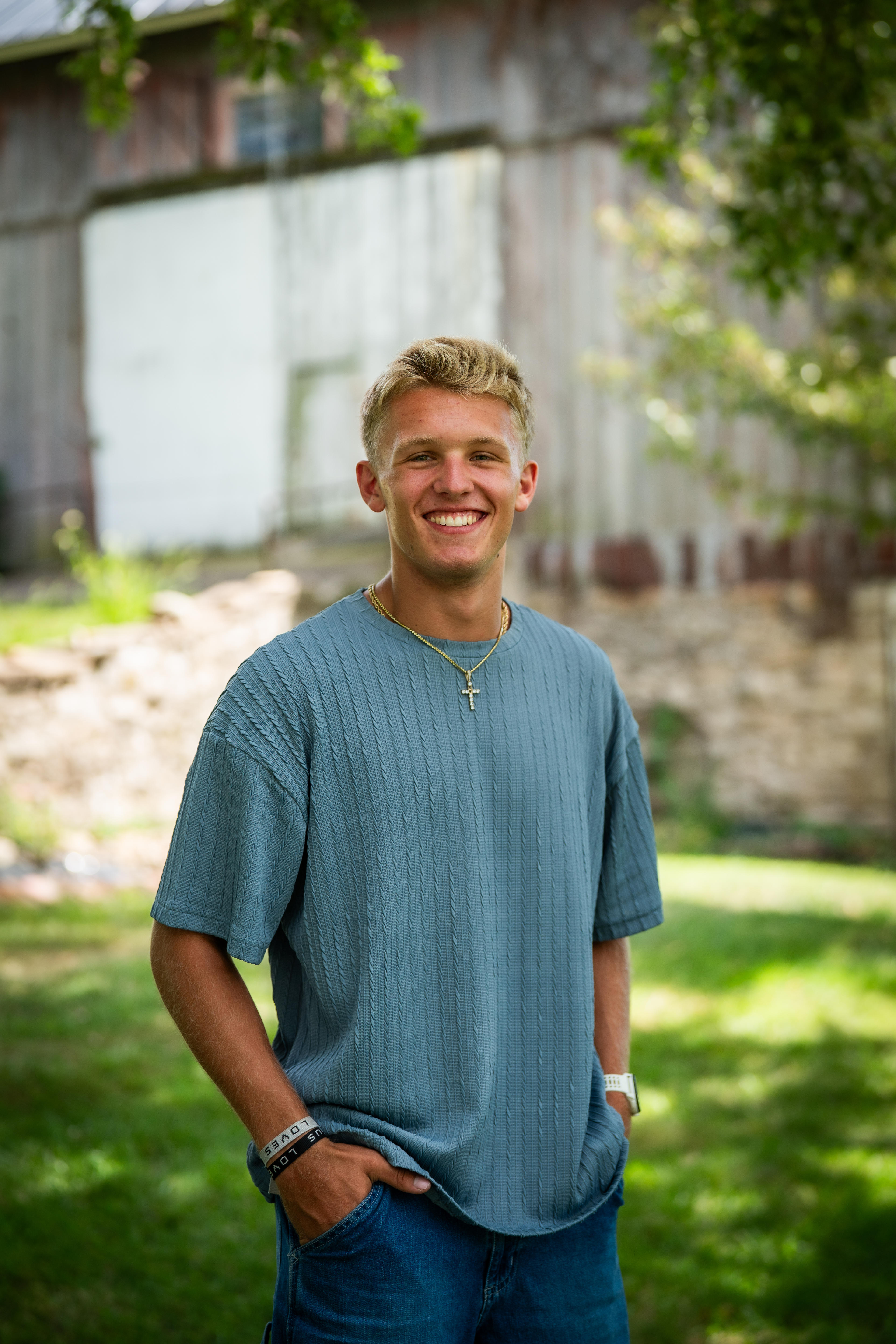 Joey Jolin, outdoor portrait near a barn