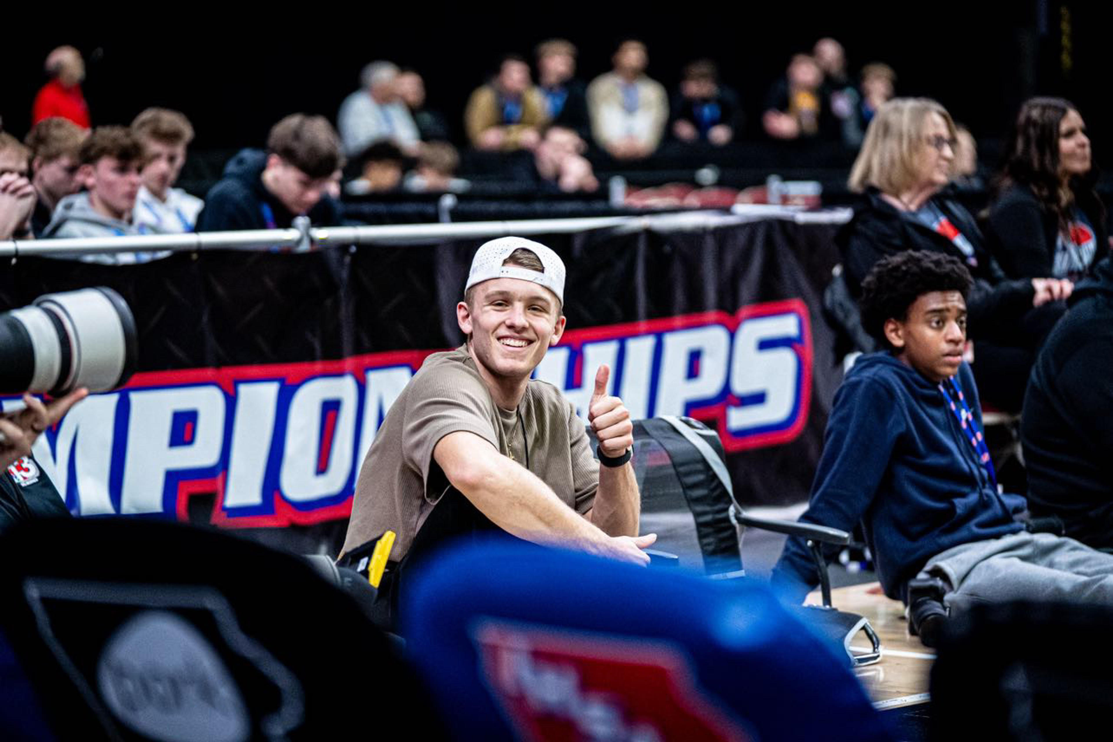 Joey Jolin courtside at a championship event, camera in hand