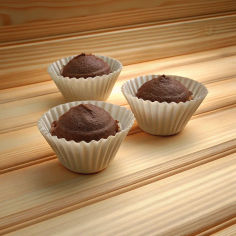 Two Coffee-flavored cupcakes on a plate.