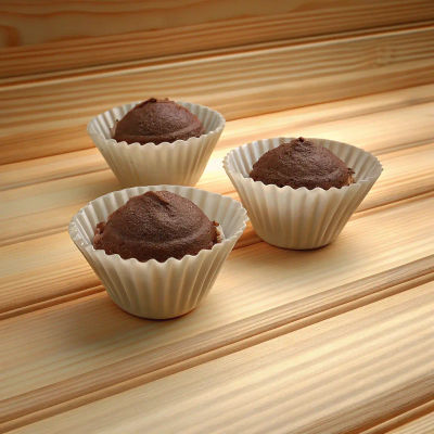 Two Coffee-flavored cupcakes on a plate.