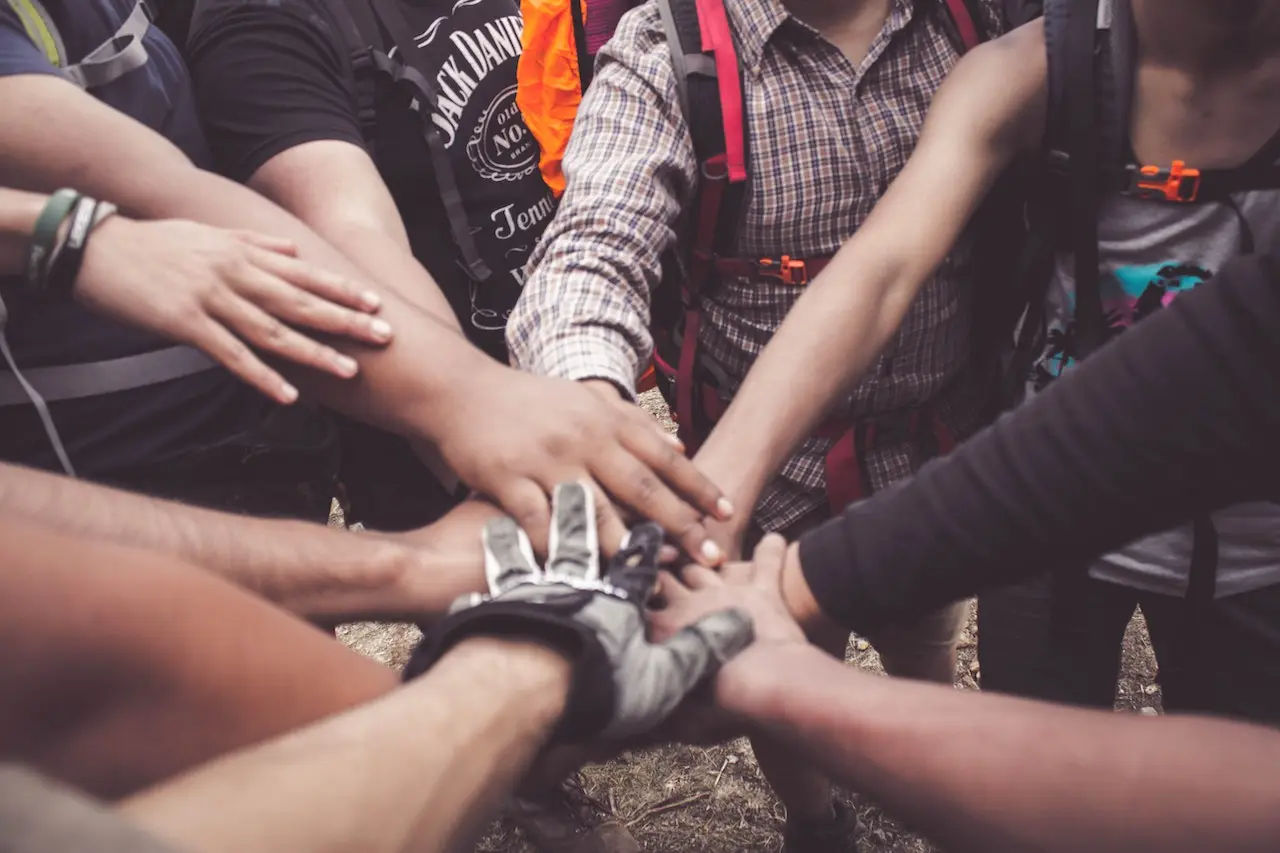 Group of employees with hands in the middle.