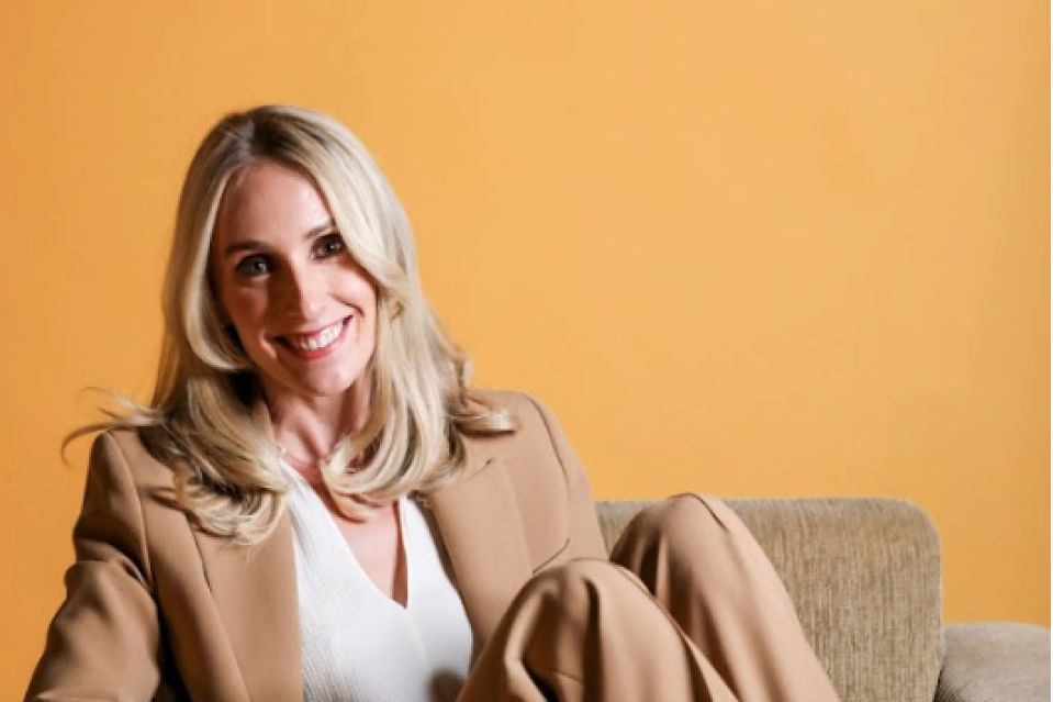 Atteline PR Dubai - Sophie posting while sitting in a couch with yellow background