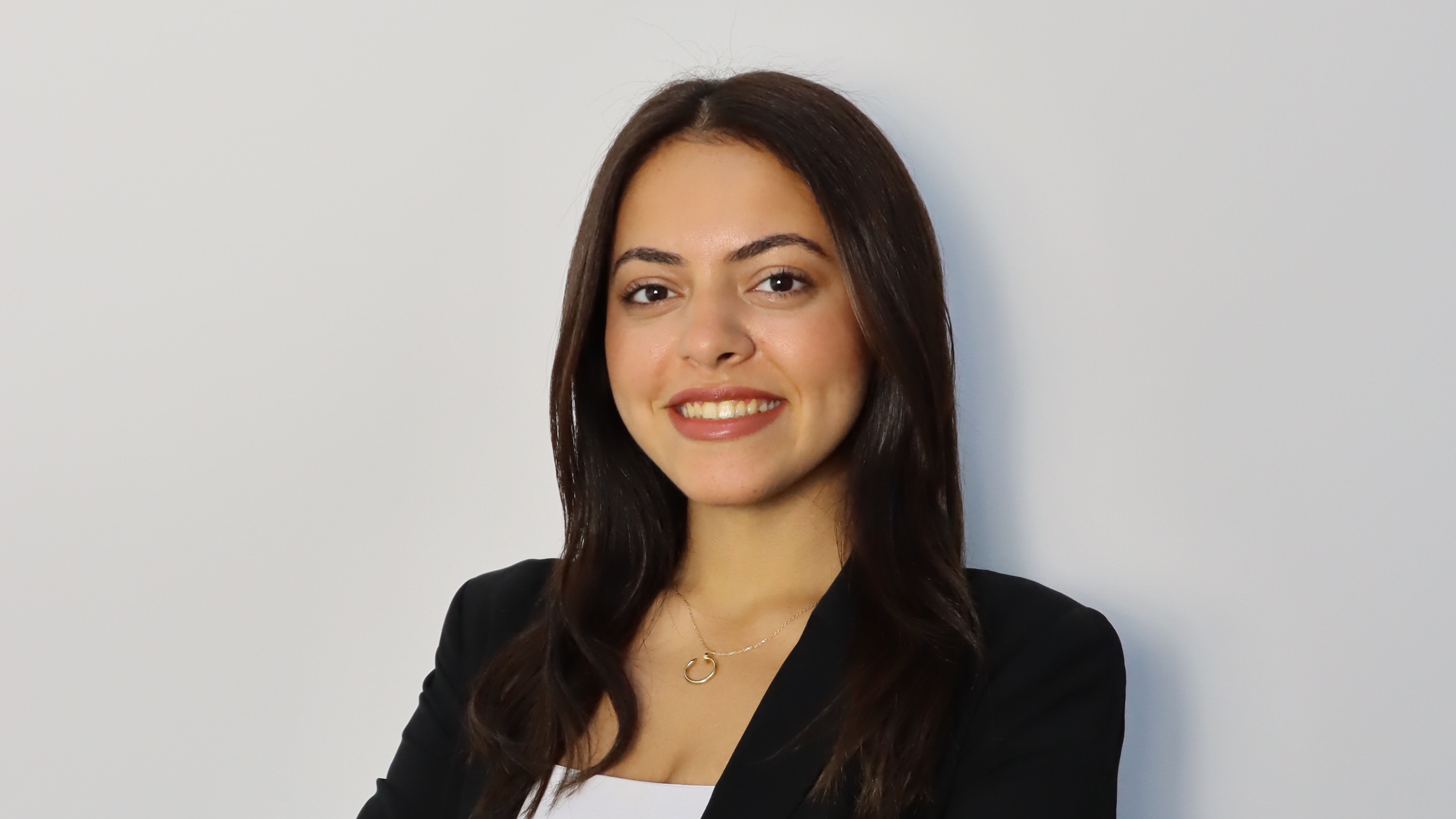 Rojina smiling in front of a wall