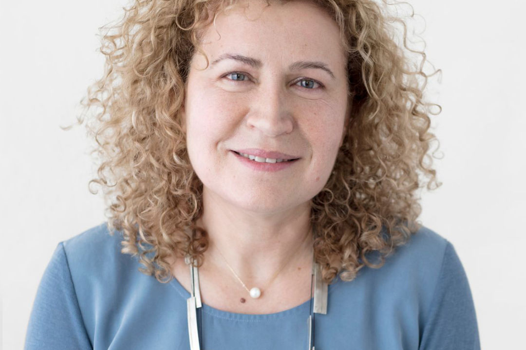 Ruder Finn Atteline - Sana wearing a blue shirt and necklace