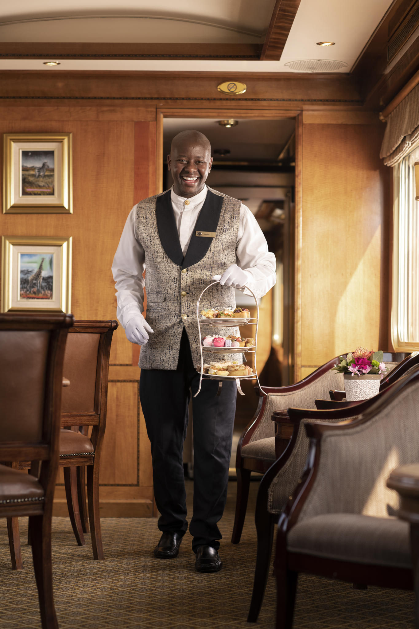 Butler serving high tea in Lounge Car