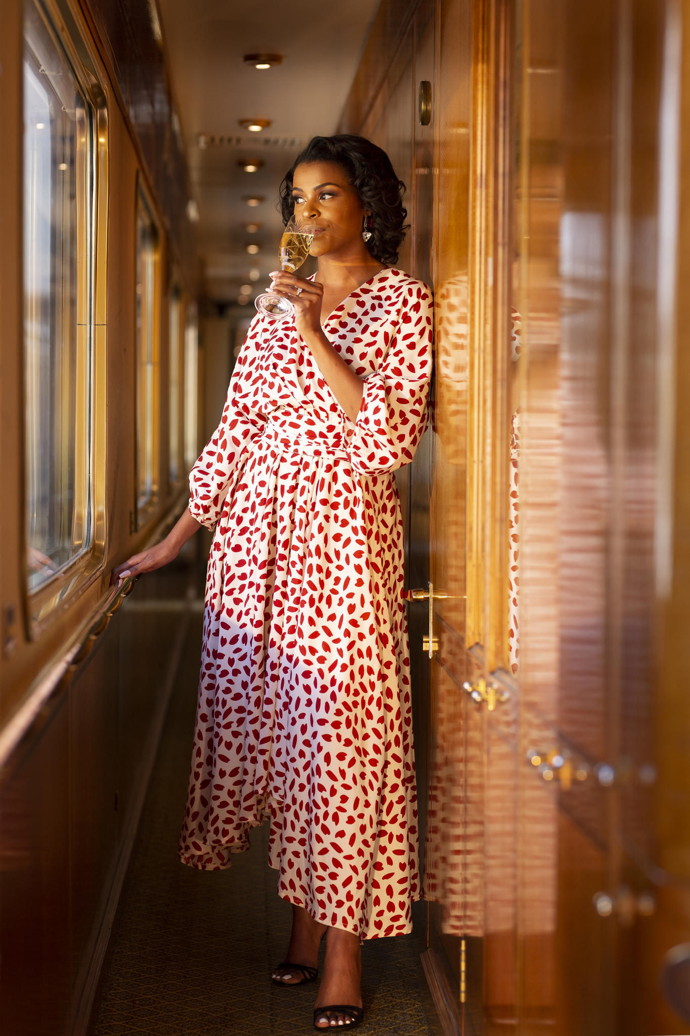 Guest enjoying champagne in corridor