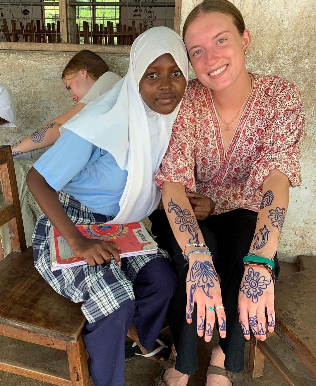 Gap Year volunteer with henna tattoos and Kenyan child