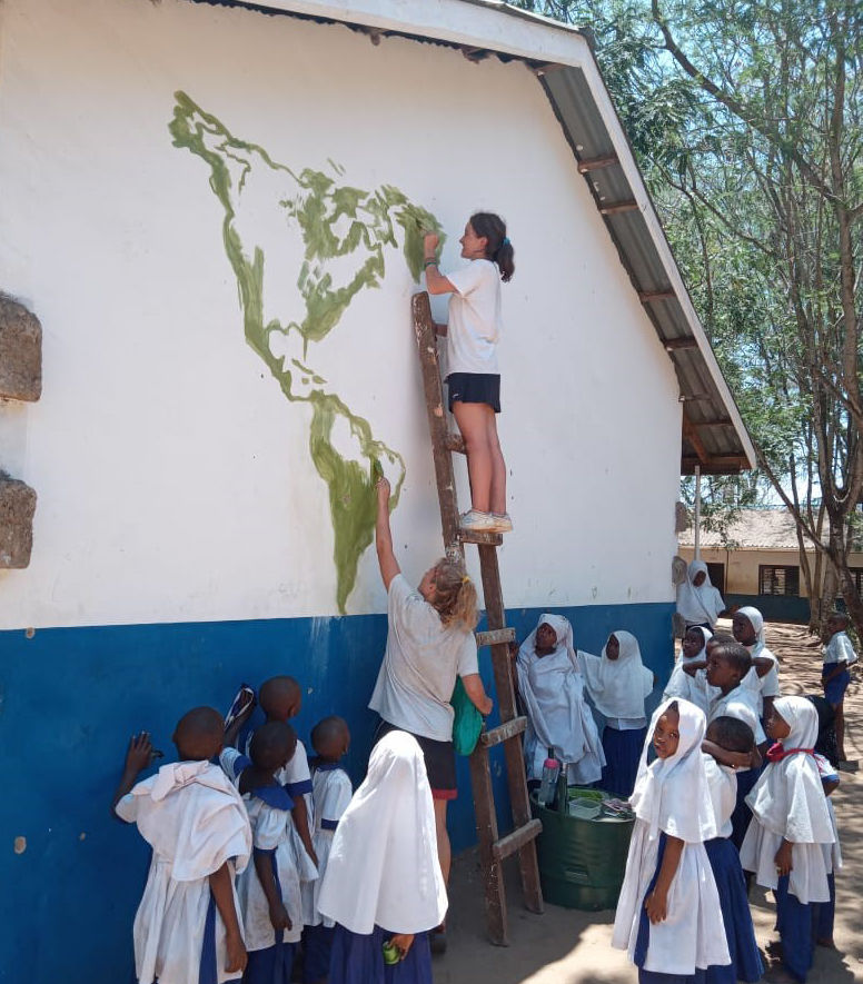 gap year volunteers painting a mural in Kenya