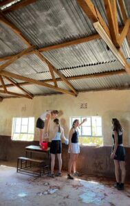 Children painting classrooms in Kenya