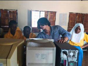Volunteer student teaching computing in Kenya school