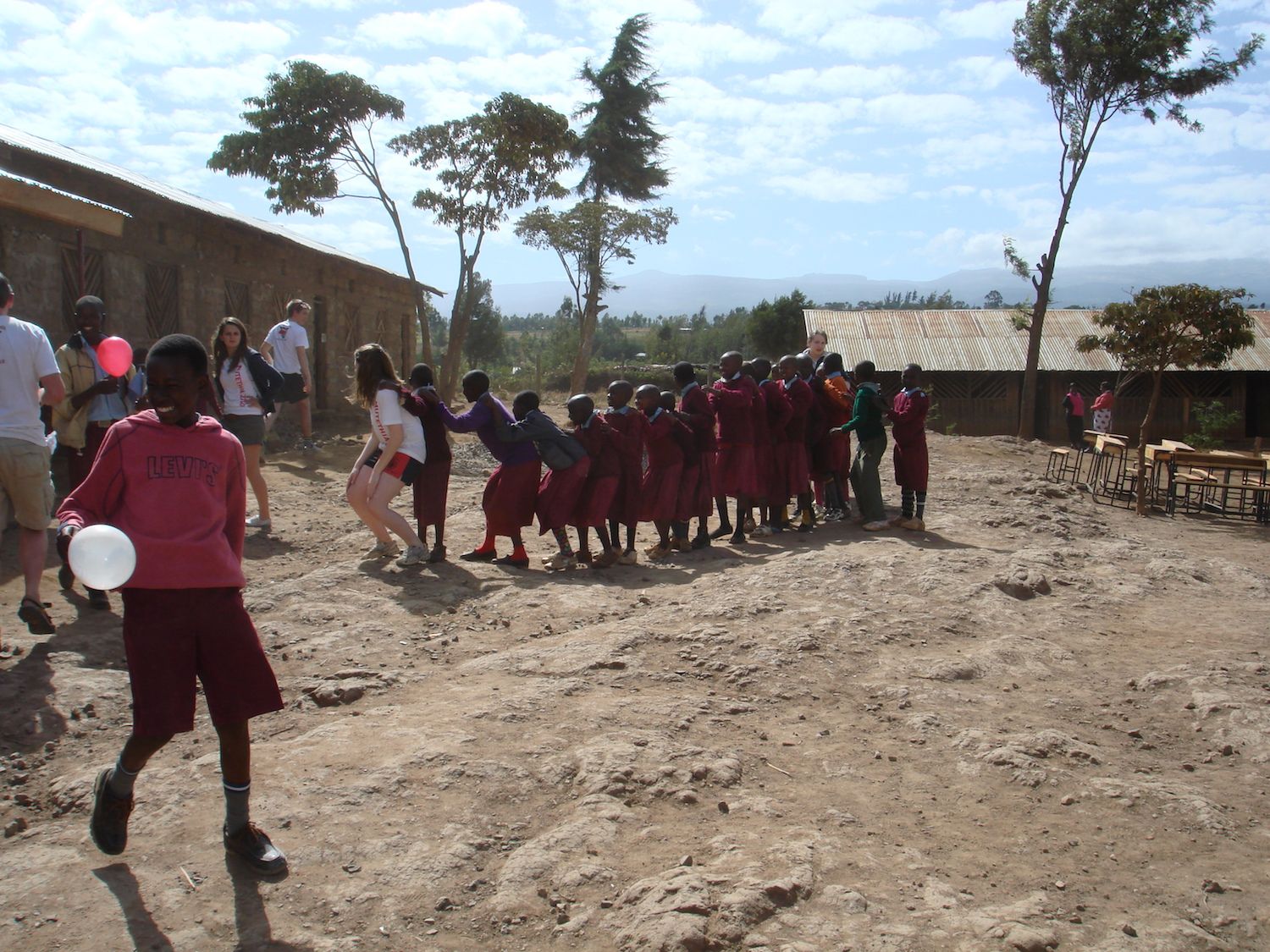 Oakham students playing with the children on their School Trips to Africa