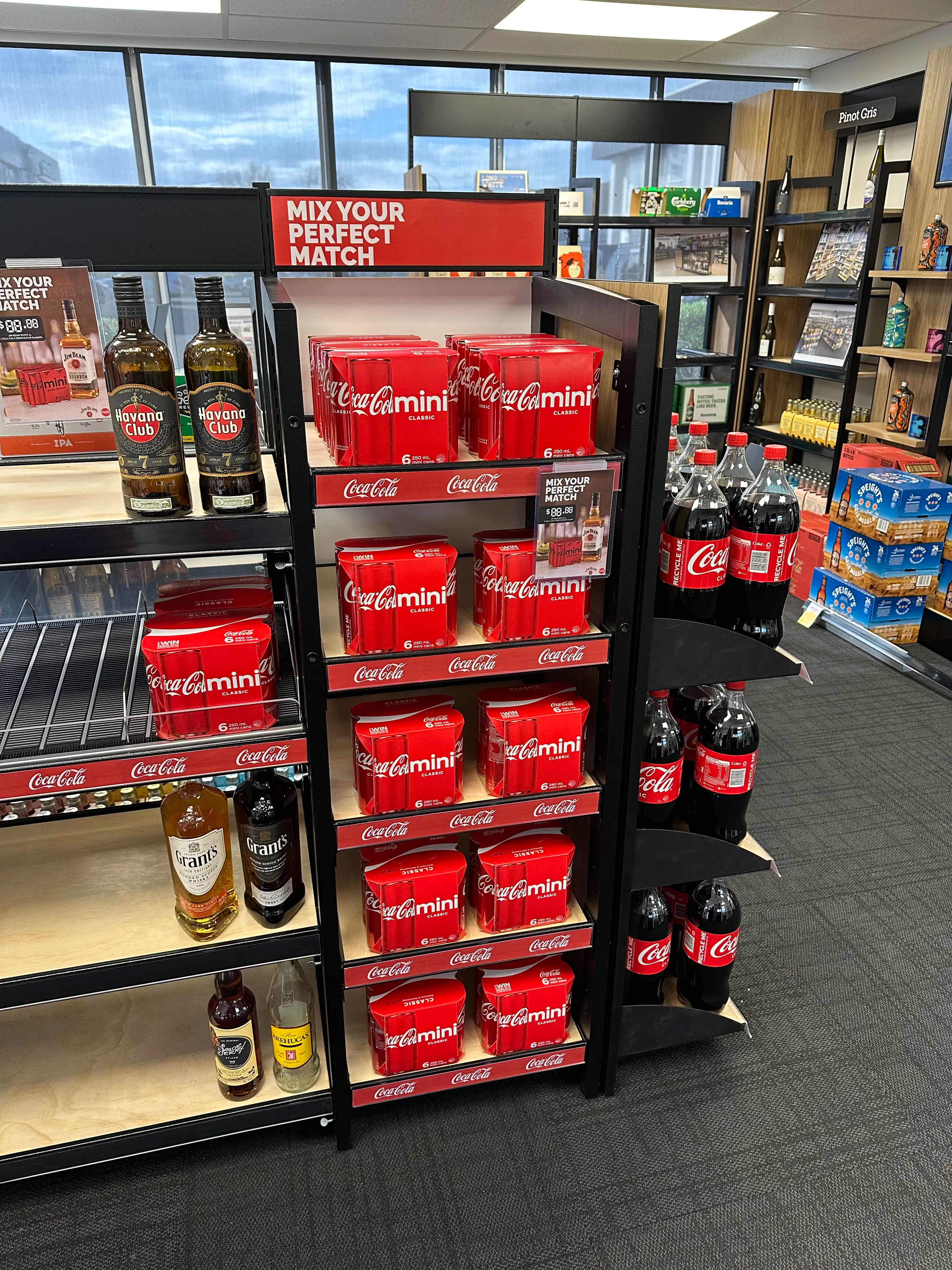Coca-Cola floor stand with bottles and promotional graphics