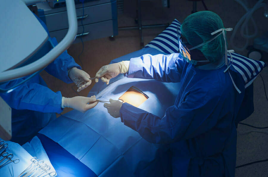 doctors performing surgery on patient