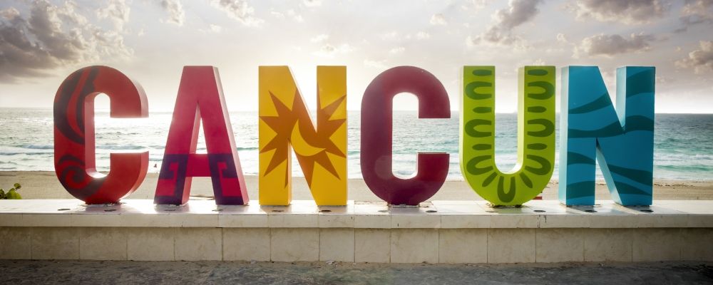 A Sign that reads Cancun with each letter having a different color