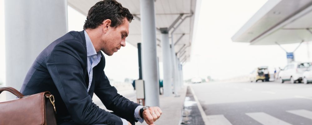 A man looking at his clock