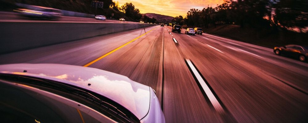 A car rushing to the sunset