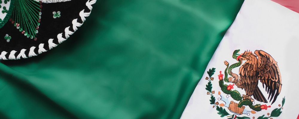 A traditional Mexican sombrero over Mexico's flag