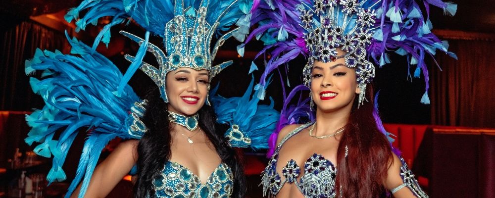 Two women dressed up for a carnival. 