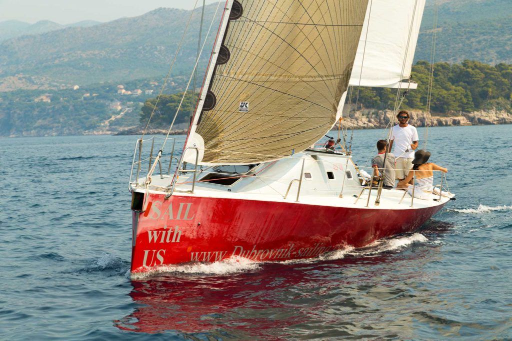 Our red sailboat beam reaching in Bay of Lapad on Full day Dubrovnik Sailing tour