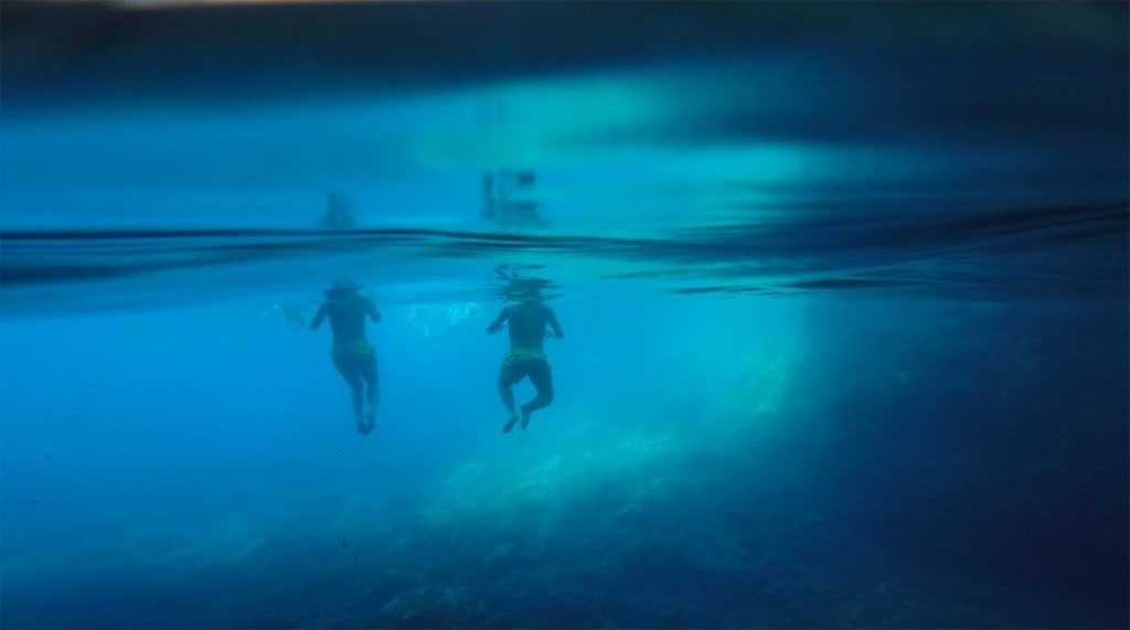 people swimming in three caves at kolocep