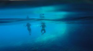 people swimming in three caves at kolocep