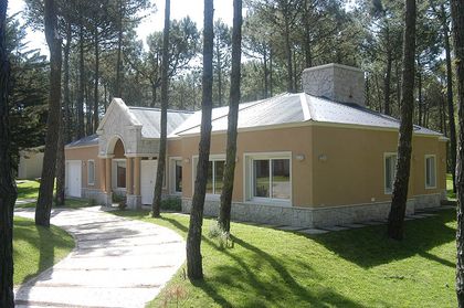fachada moderna en bosque con patio — proyecto Casa Cariló 2005, por Hugo Zawadski Arquitectos, en Cariló