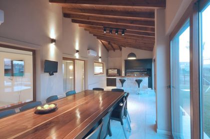 Comedor moderno con mesa de madera y vistas panorámicas amplias — proyecto TRV 195, por Estudio Arq Daniel Tarrio