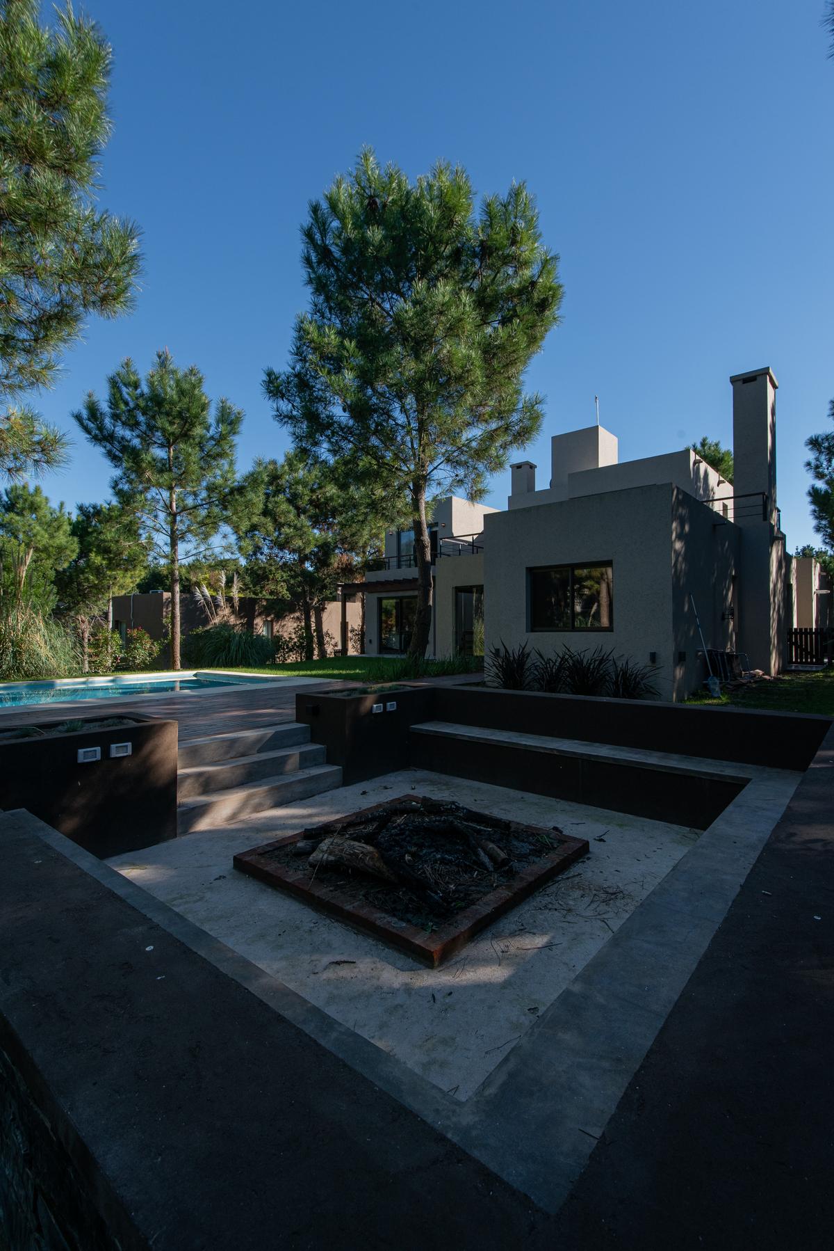Casa moderna com piscina e lareira externa — projeto Costa Esmeralda 1, por Arquitecto Caceres, em Costa Esmeralda
