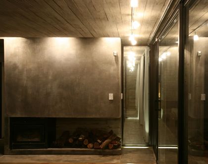 Living contemporaneo con hogar integrado y ventanal vidriado — proyecto Casa de Hormigón, por Luciano Kruk
