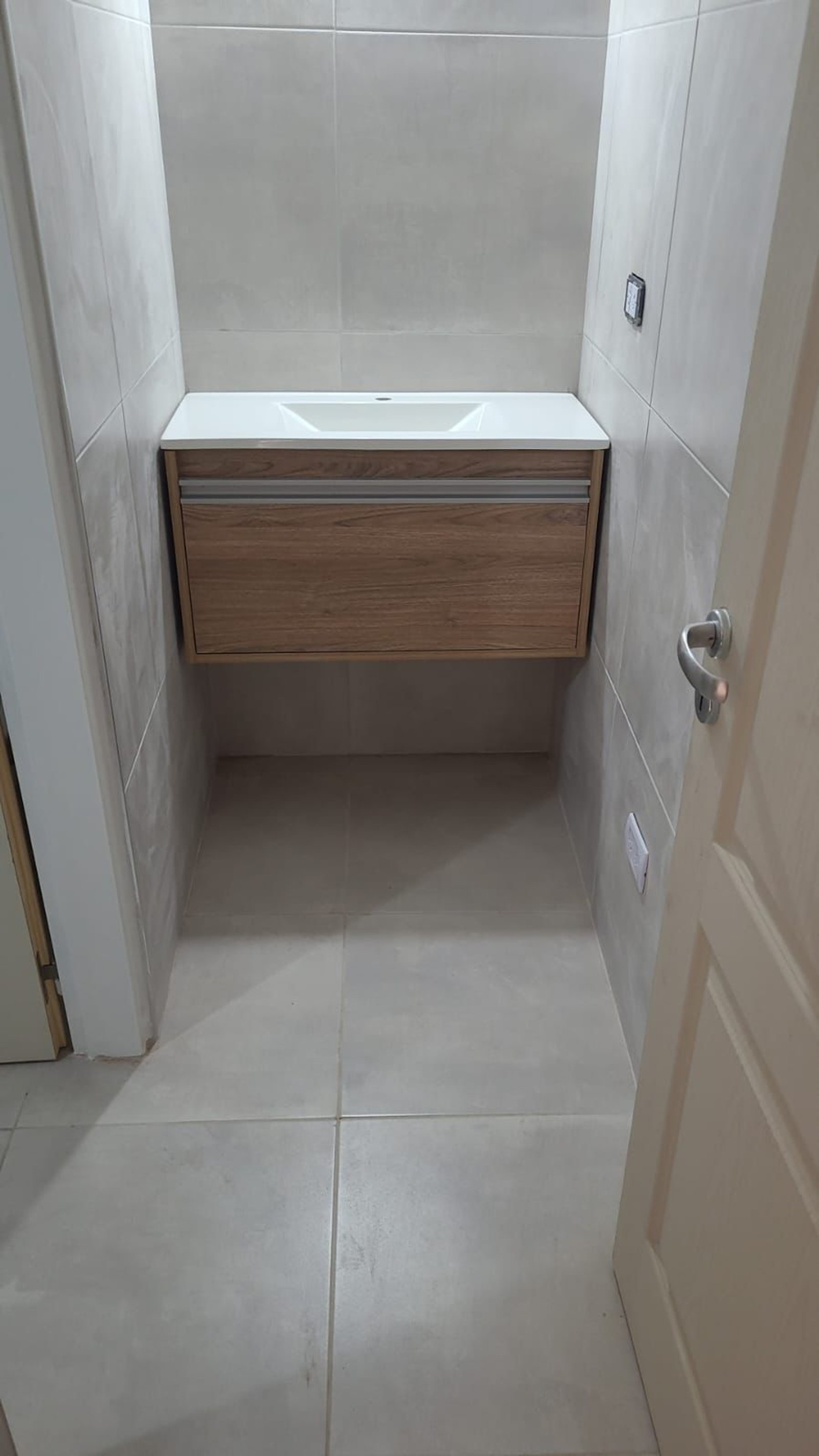 Baño moderno con vanitory de madera, bacha blanca y azulejos grises — proyecto Proyecto D, por D'Agostina , en B1663 San Miguel