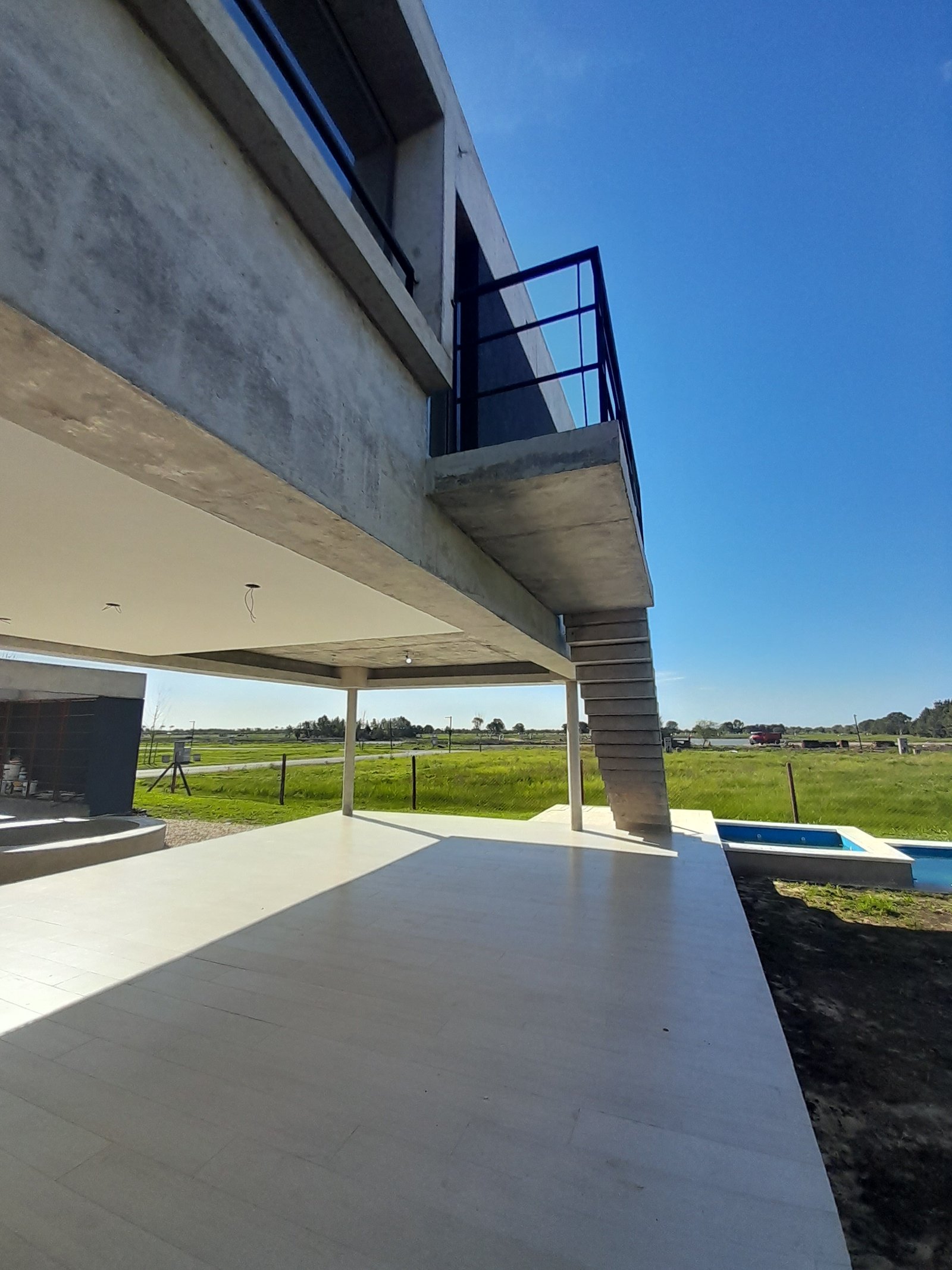 Casa moderna com escada de concreto e piscina — projeto Puerto Nizuc, por Estudio Fernandez Long & asoc., em Au Dr. Ricardo Balbín km 31.5