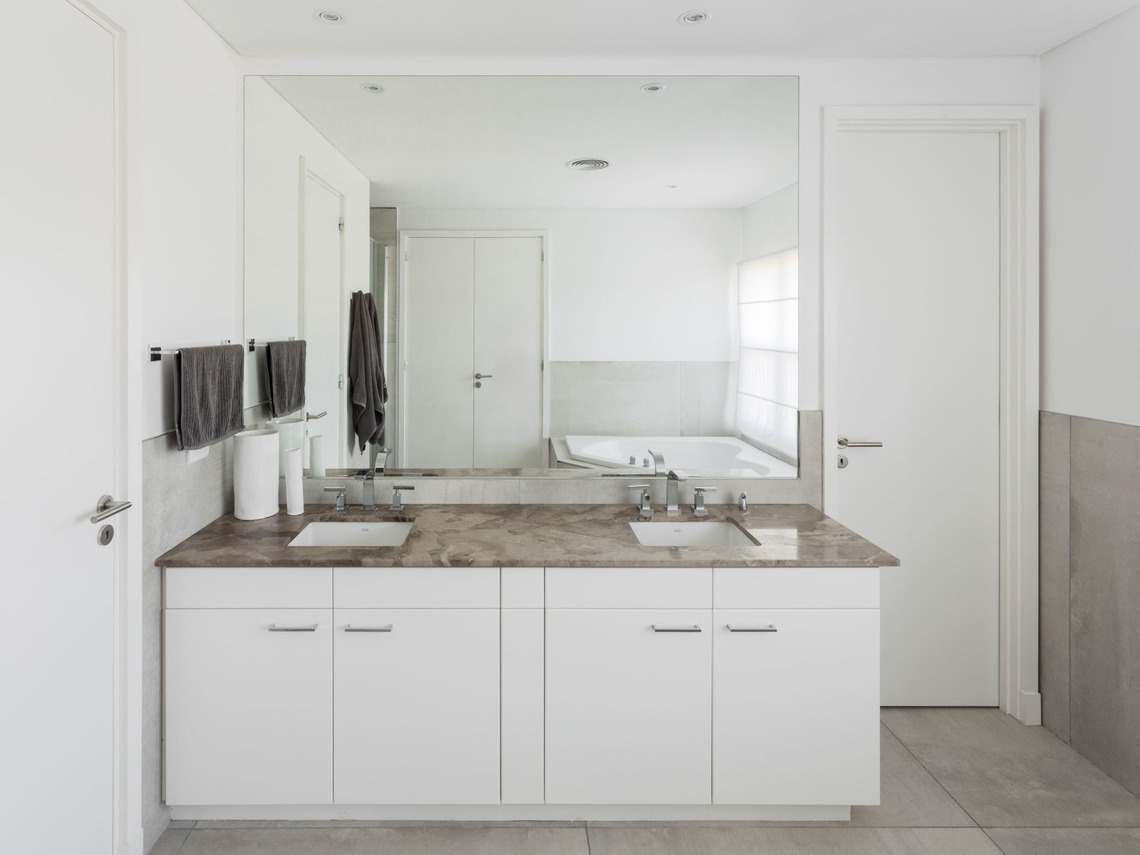 Baño moderno con doble lavabo, encimera de mármol y amplios armarios blancos — proyecto REFORMA GDLT, por Rastro Estudio, en Nordelta