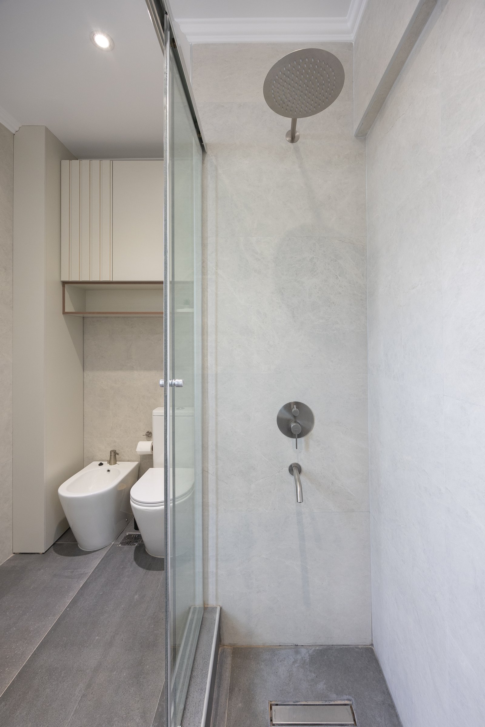 Baño moderno con bidet, inodoro y ducha minimalista — proyecto Balvanera, por Martina Kleinert, en C1032 Buenos Aires