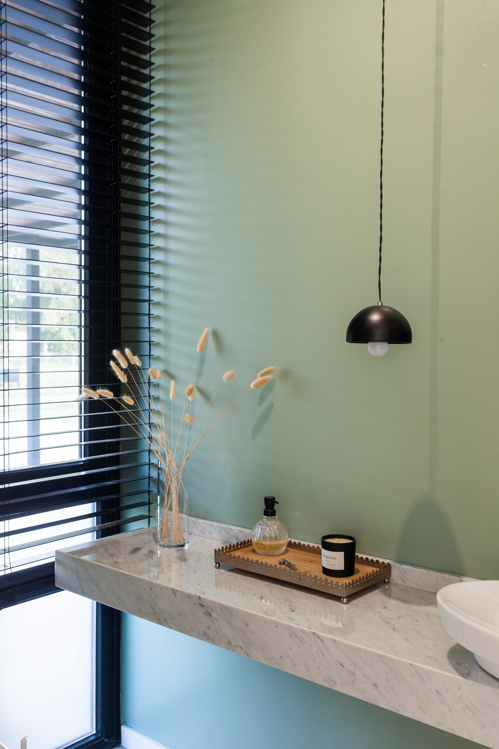 Baño moderno con pared verde y detalles en mármol — proyecto CASA HS143, por A'PRIMA - Arquitectura Sustentable, en km 7.5 Ruta 25