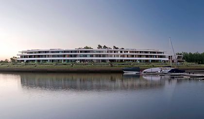 edificio moderno curvo frente al mar — proyecto Marinas del Yacht, por Estudio Ramos, en Nordelta