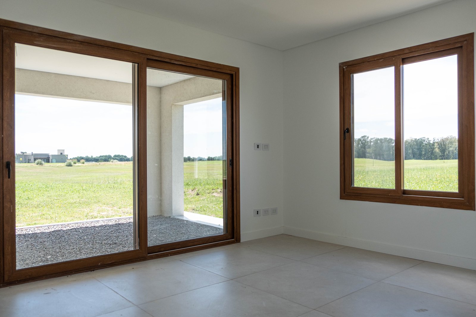 Living comedor moderno con vista al campo — proyecto CASA GOLF, por SEDE Arq., en Av. Pereda S/N