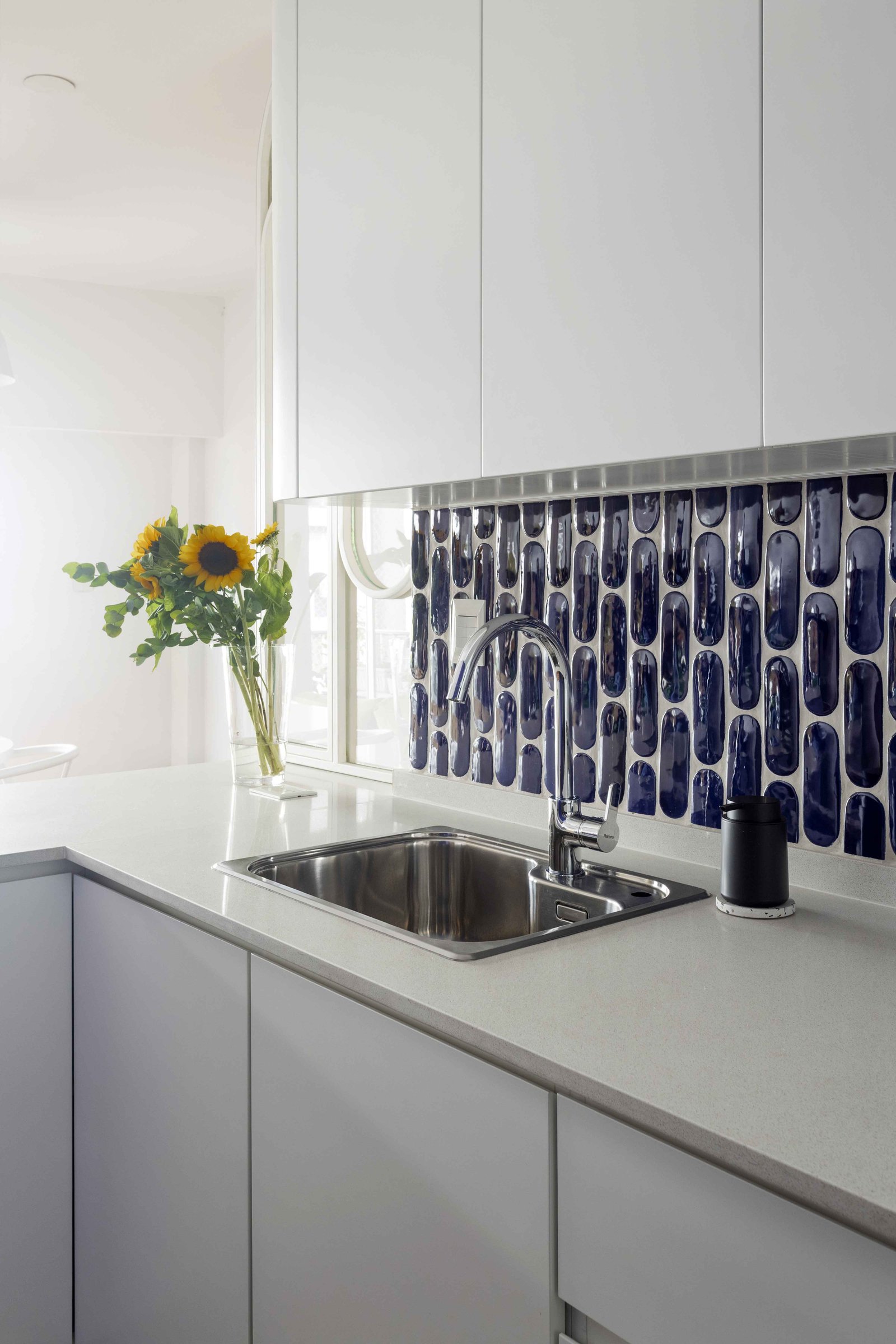 Cocina moderna con detalles azules y girasoles — proyecto Julián Alvarez, por Bouré Studio, en Palermo