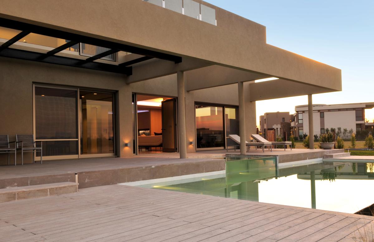 Área de piscina moderna com deck de madeira — projeto Moderna Seducción, por Apaarquitectura, em Tigre