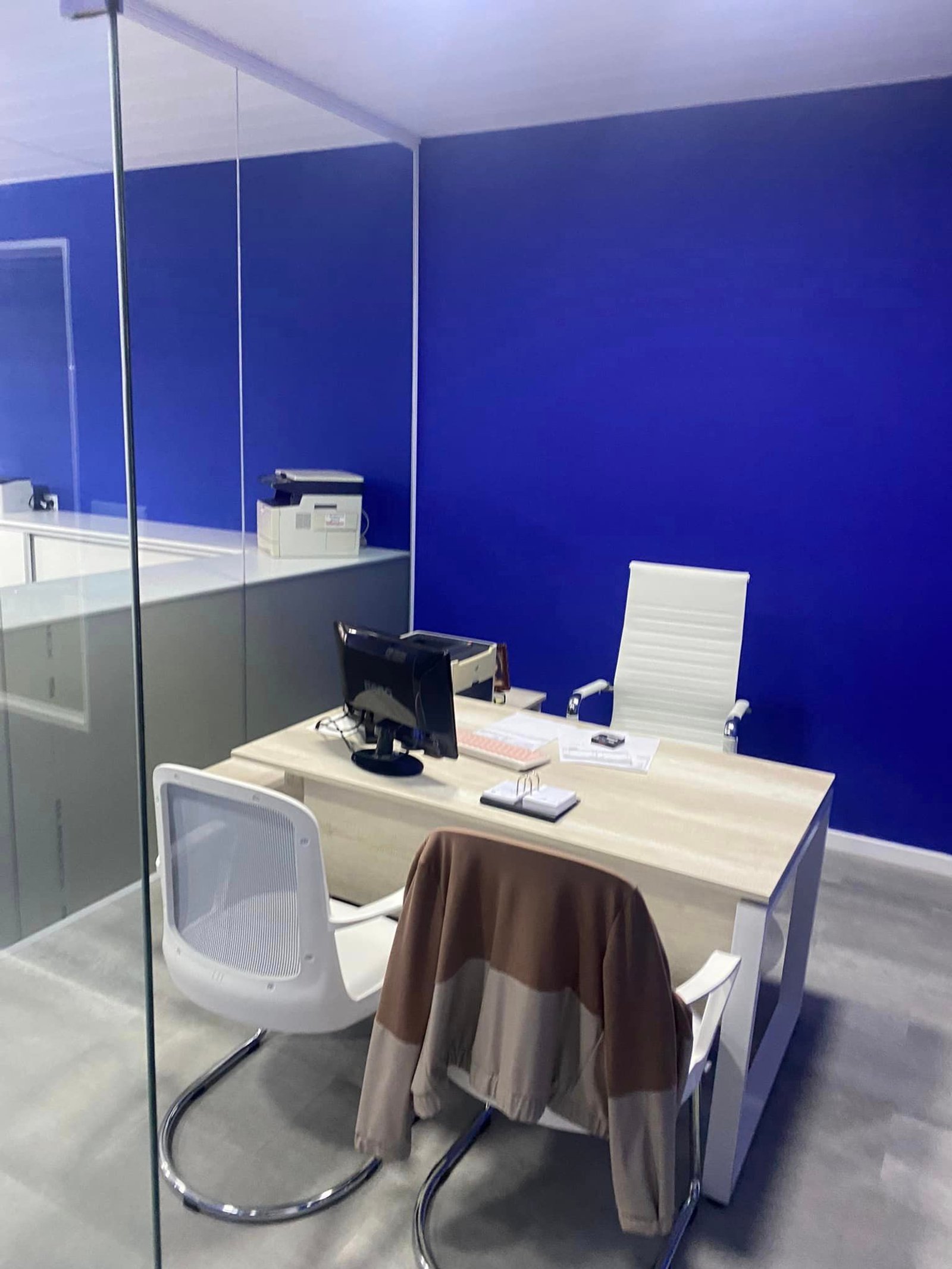 Escritório moderno com parede azul vibrante e mesa de madeira — projeto Esudio Contable, por Arquitecto Gustavo Maidana, em Caá Catí