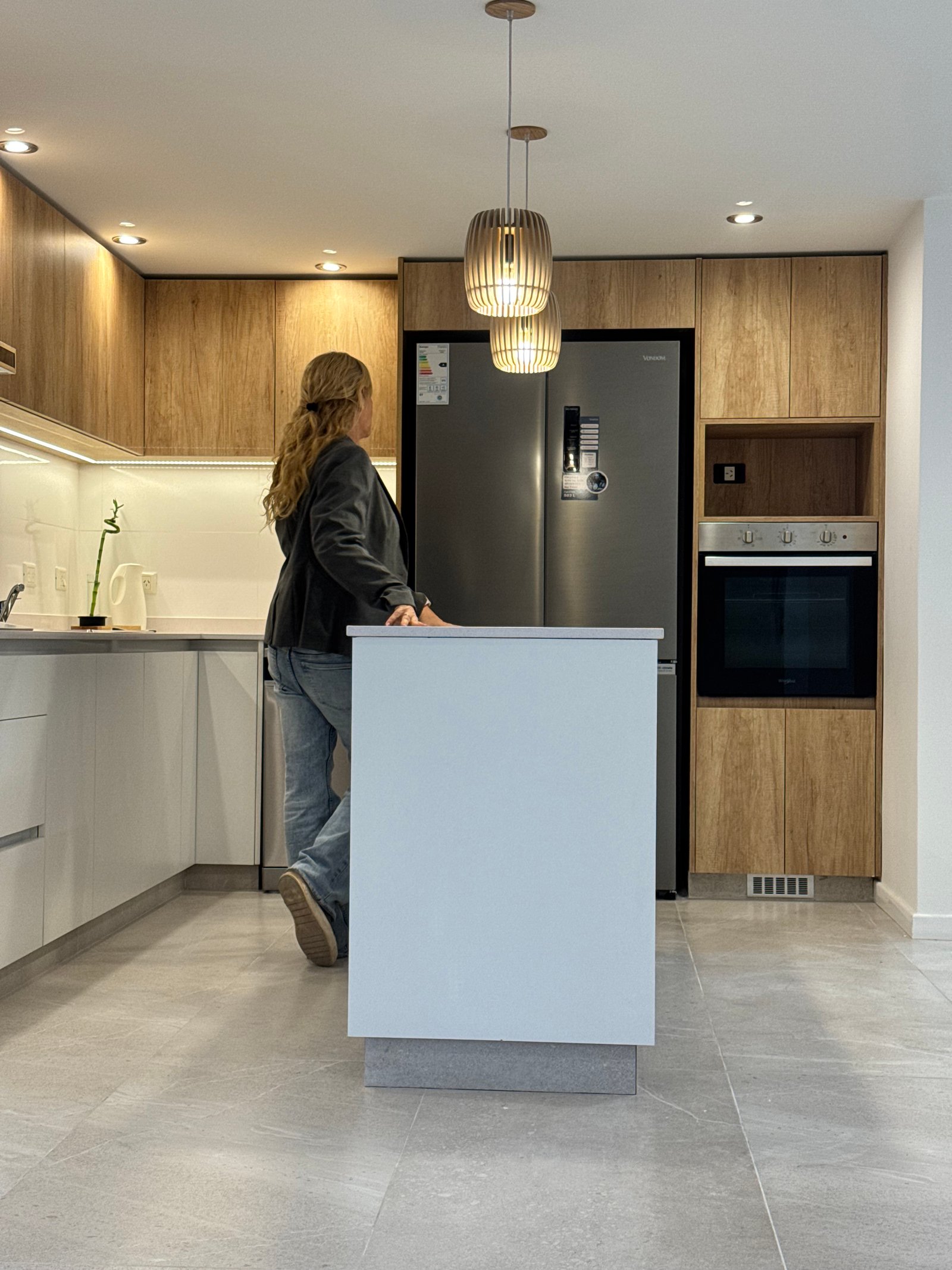 Cocina moderna con isla, isla blanca y muebles de madera — proyecto NEWBERY, por Estudio Grupo 32, en lavalle 2501