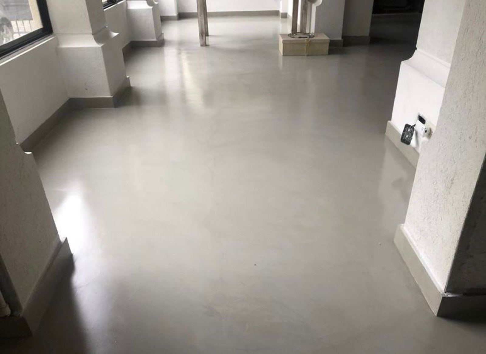 pasillo comercial con suelo de microcemento y columnas de hormigón — proyecto Casa particular en Victoria, por PROTEX, en Victoria