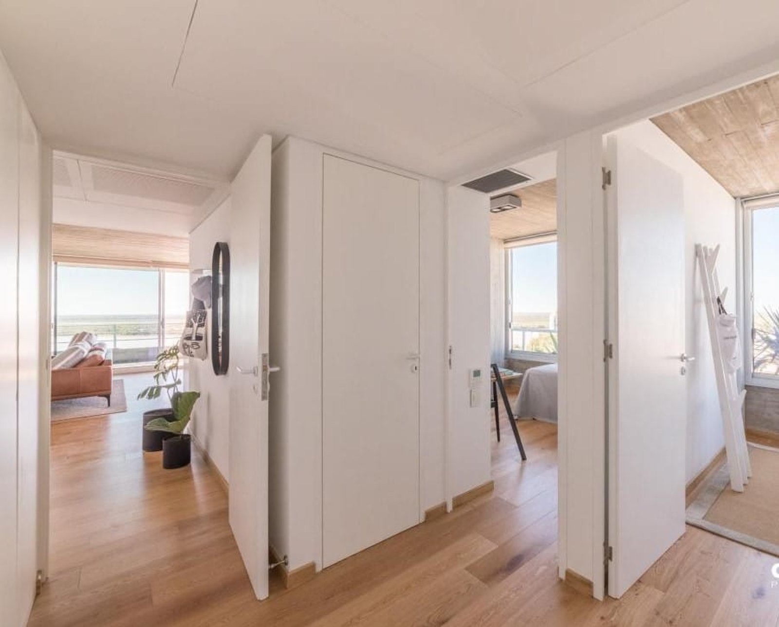 Pasillo moderno con piso de madera y techos de hormigón visto — proyecto Costavia, por Quento, en Av. Rivadavia 2569