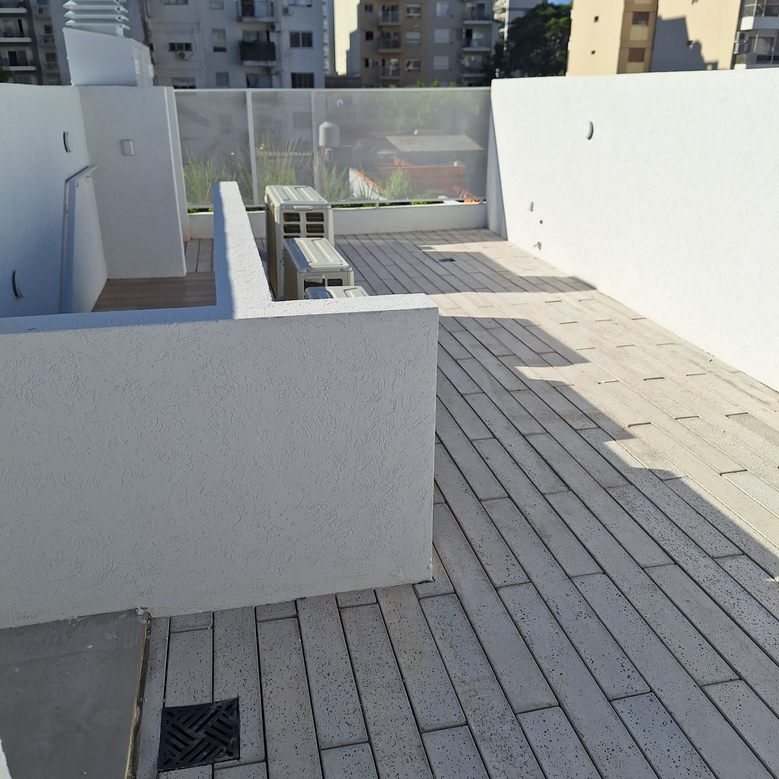 Terraço de varanda moderno com piso de tijolos bege e paredes brancas — projeto Edificio Escribano, por LW Lopez Wolder arquitectos, em Pasaje Escribano 66
