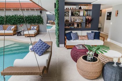 Espacio integrado con pileta, living y detalles boho en tonos neutros — proyecto Casa Barra ED, por Amanda Miranda