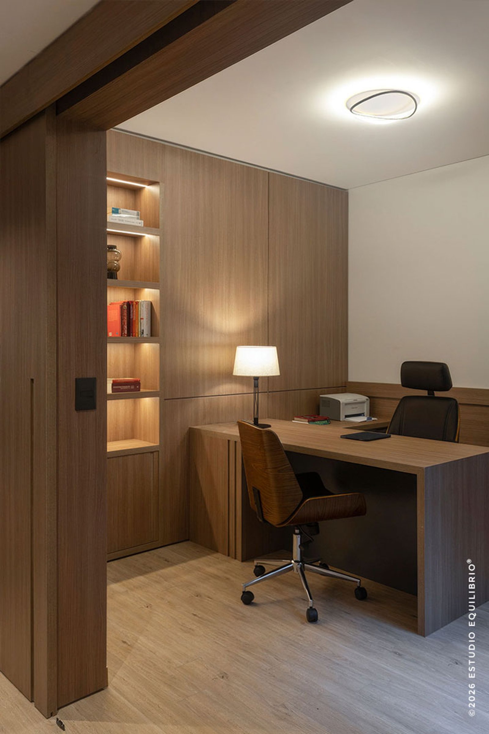 Oficina moderna con escritorio de madera y silla ergonómica — proyecto Proyecto Zapiola, por Estudio Equilibrio, en Belgrano