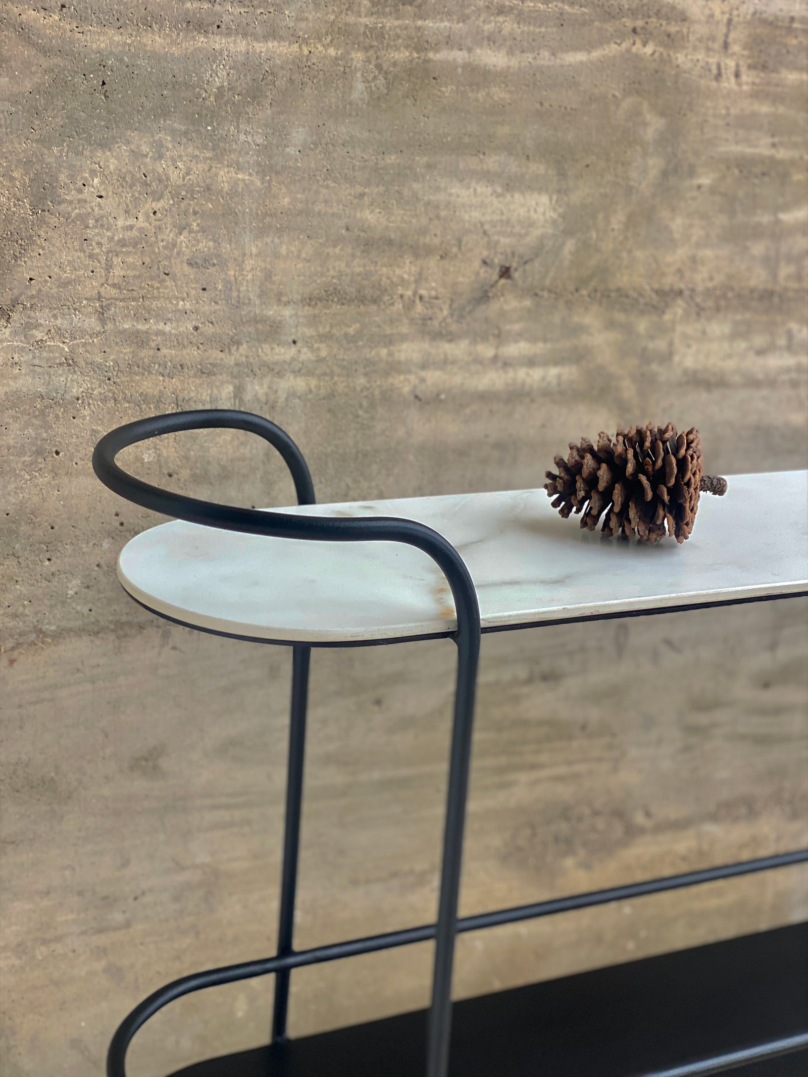 Mesa alta moderna de mármol y metal negro contra pared de cemento texturizado — proyecto Línea Bauhaus, por Línea Bauhaus, en Ciudad de Córdoba