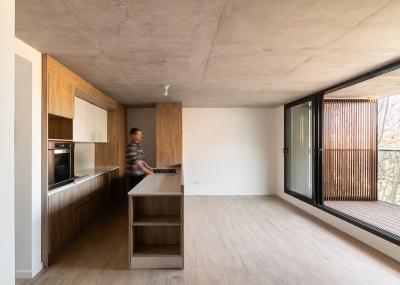 Cozinha moderna integrada com teto de concreto e móveis de madeira — projeto EDIFICIO PATRIMONIO, por DIB OBRIST Arquitectas, em Rosario