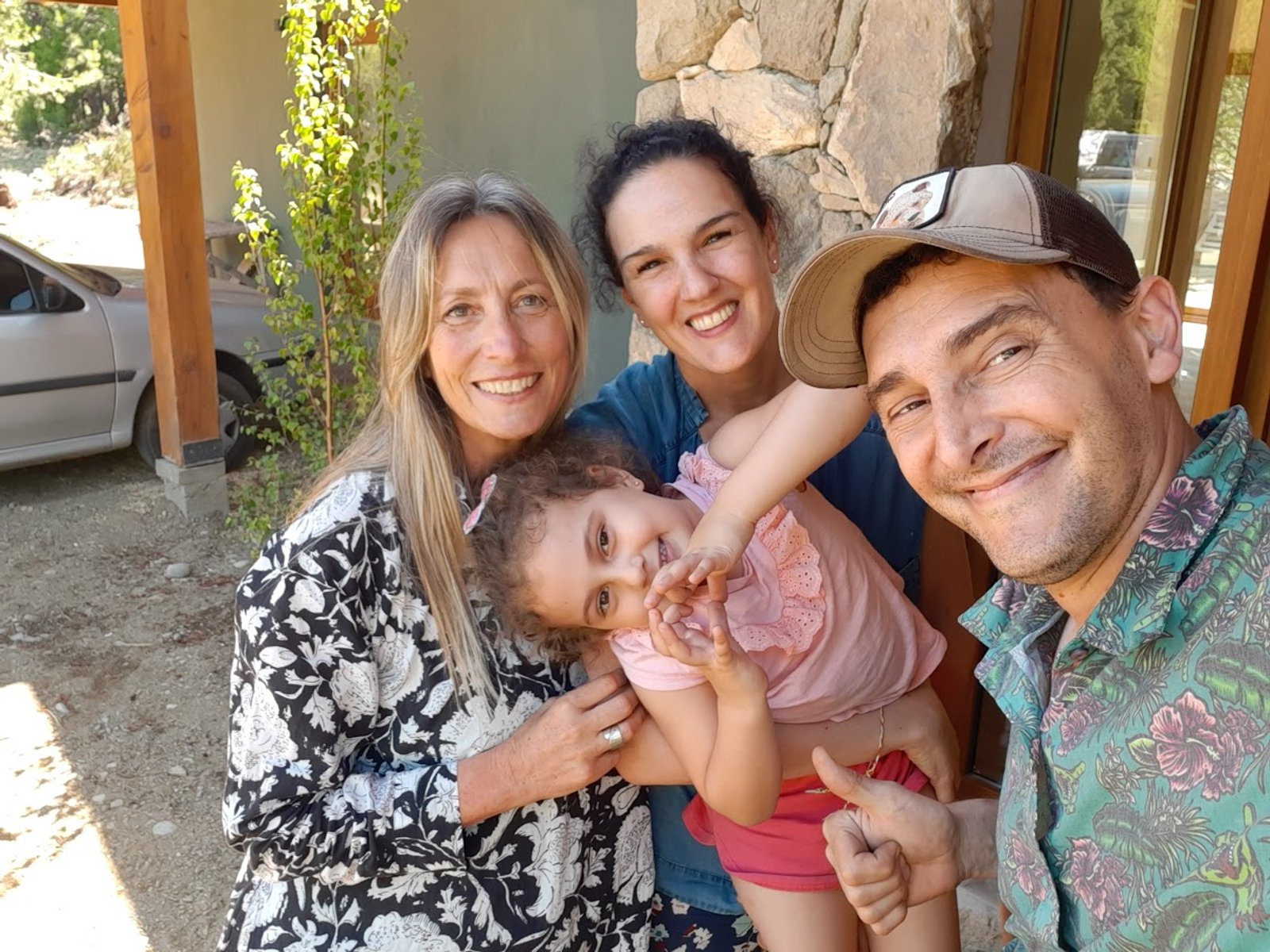 familia posando frente a casa de campo rústica — proyecto Proyecto Casa SZ, por Arquitecta Grace Overgaard, en Acceso Al Challhuaco
